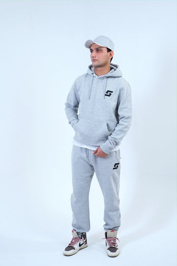 Men's gray jogger tracksuit with pullover hoodie and sweatpants, ideal for casual wear or workouts.