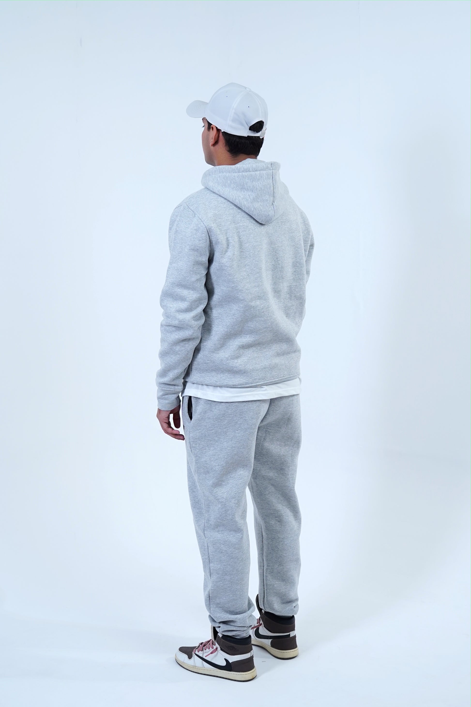 Men's gray jogger tracksuit with pullover hoodie and sweatpants, perfect for streetwear, workouts, or lounging.